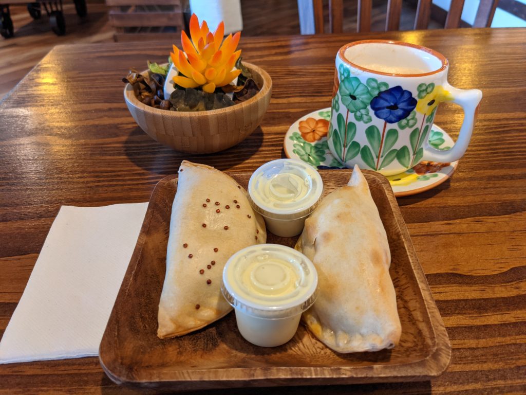 An empanada and Dulce de Leche Cappuccino at CFS Coffee